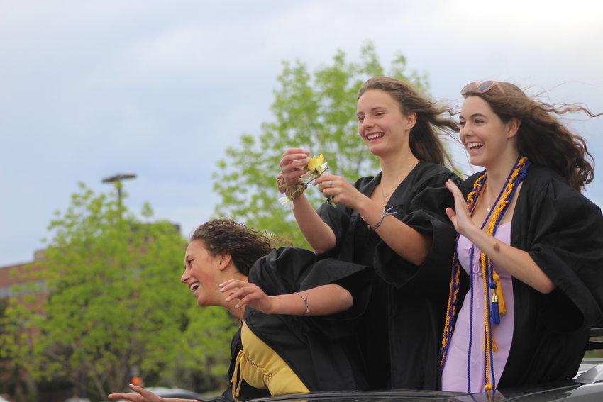 Seniors from Lakewood High School smile as they drive through the school's parking lot. Jeffco Public Schools is aiming to hold graduations in August.
